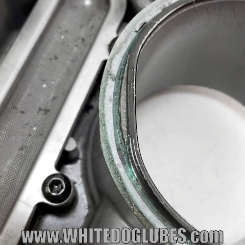 Close up of the rubber O ring out of position in the engine oil sump